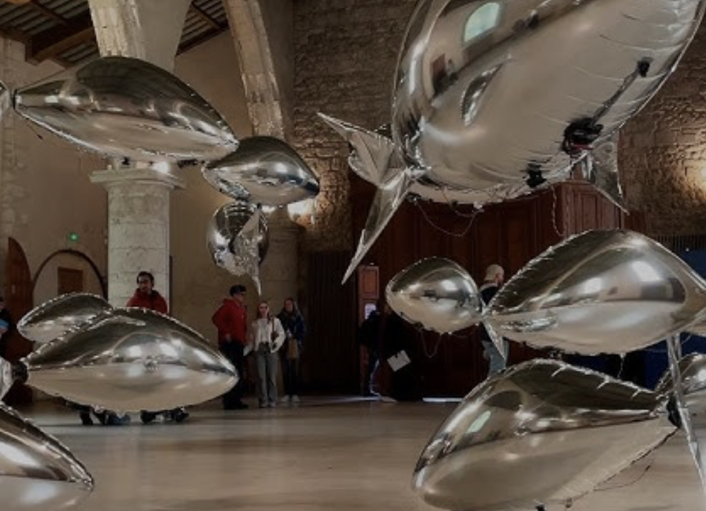 People at a concert facing the stage with various colours of paint powder in the air